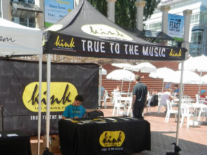 intern texting at kink radio promo tent